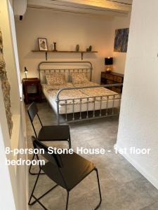 a bedroom with a bed and a chair at Murter-Sun Stone House in Murter