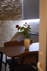 a vase with a flower on a wooden table at Sunny Home in Ijevan +4 photos
