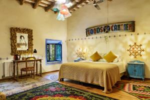 a bedroom with a bed and a table and a mirror at Can Portell by 123ole, B&B - Casa Rural in Sant Andreu del Terri