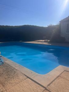 a large pool of blue water on a patio at Shepherds Hut in Shropshire with Swimming Pool in Shifnal