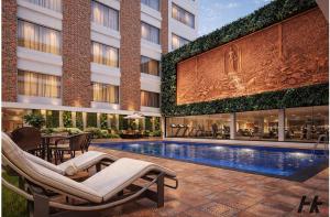 a hotel with a swimming pool and a building at Laa Montre Kharagpur in Barādiha