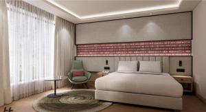 a bedroom with a bed and a green chair at Laa Montre Kharagpur in Barādiha