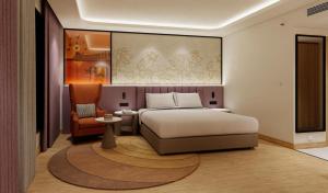 a bedroom with a bed and a chair at Laa Montre Kharagpur in Barādiha