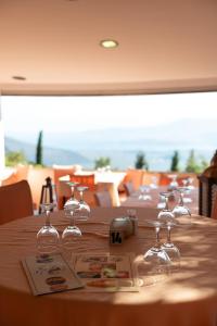 a table with wine glasses on top of it at Bungalow - Camping Apollon in Delphi