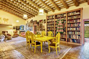 a dining room with a table and chairs and a christmas tree at Can Portell by 123ole, B&B - Casa Rural in Sant Andreu del Terri