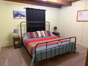 a bedroom with a bed with a black metal frame at Elevation Station Surrounded by Wildlife in Angel Fire