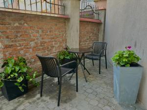 a patio with chairs and a table and some plants at Mini home apartment in Ternopil