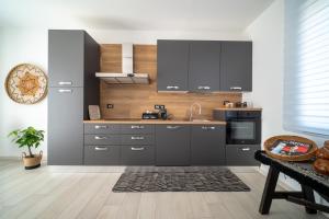 a kitchen with gray cabinets and a sink at Civico 91 Guest House in Silì