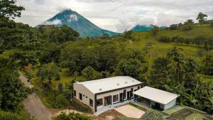 an aerial view of a house with a mountain in the background at River Suite at Luna Negra Suites & Spa in El Castillo de La Fortuna
