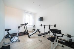 a gym with several exercise bikes and treadmills at Civico 91 Guest House in Silì