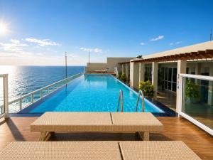 a swimming pool on the balcony of a building at Beachfront Sky Studio with Ocean View in Wattala