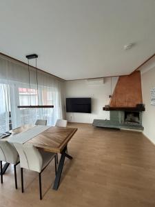 a dining room with a table and a fireplace at Krumpendorf 1 in Krumpendorf am Wörthersee
