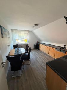 a kitchen with a table and chairs in a room at Lenyanca Apartment in Salzbergen
