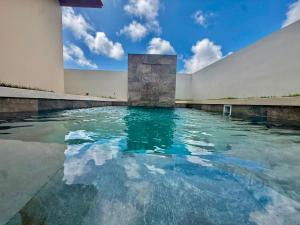 a pool of water in front of a building at Paradise Cove in Punta Cana