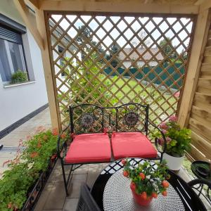 a patio with a bench and a table with flowers at JULIANNA APARTMAN Budapest FREE PARKING in Budapest