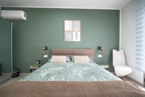 a bedroom with a large bed with blue walls at Civico 91 Guest House in Silì