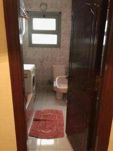 a bathroom with a sink and a toilet and a window at New Maadi Apartment in Cairo +36 photos