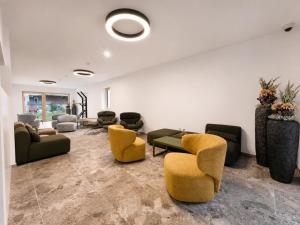 a large living room with couches and chairs at BASE Achensee - Opening August 2026 in Achenkirch