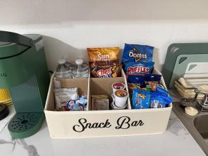 a box filled with snacks on a kitchen counter at Your Blooming Getaway in Nassau
