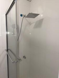 a shower stall with a glass door with a shower at Your Blooming Getaway in Nassau