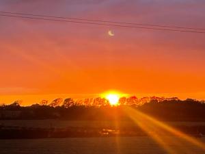 a sunset with the sun in the sky at Yurt - The Spinney in Faringdon