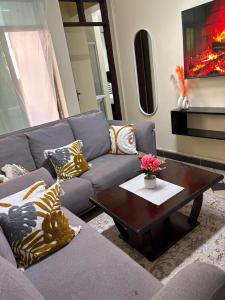 a living room with a couch and a coffee table at Terry's 2br sunsweet resort shanzu,mombasa in Mombasa