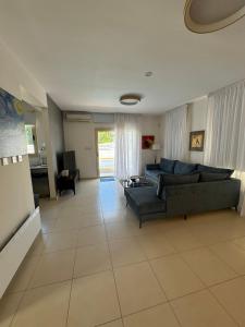 a living room with a couch and a table at Paez Villa - Private Pool - 3BR - Walk to Beach - Pernera Protaras in Protaras