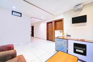 a room with a kitchen and a living room at Super Townhouse LIG Main Road Indore in Indore