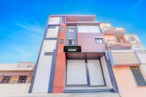 a tall building with a sign on it at Super Townhouse LIG Main Road Indore in Indore +22 photos