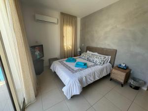 a bedroom with a bed with a tray on it at Paez Villa - Private Pool - 3BR - Walk to Beach - Pernera Protaras in Protaras +21 photos