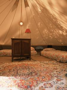 a room with two beds and a table in a tent at Auberge Aparra Surfcamp Ondres in Ondres +18 photos