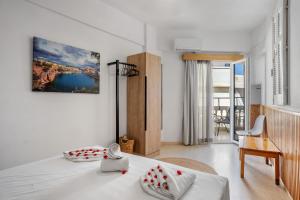 a white room with a bed and a table and a desk at Malia Boutique Studios in Malia +85 photos