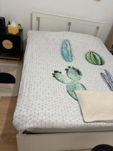 a bed with a white bedspread with cilantro at L appart in Joué-lès-Tours