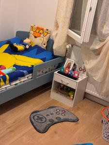 a childs bedroom with a bed and a rug at L appart in Joué-lès-Tours