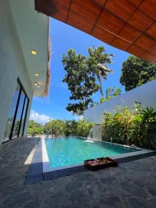 a swimming pool in the middle of a house at Ruchi Villa in Wadduwa