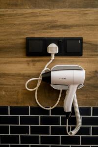 a white hair dryer is attached to a wall at Ruchi Villa in Wadduwa