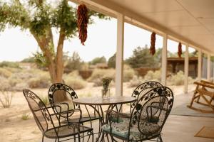 a table and chairs sitting on a patio at El Ranchito Alegre Private 3BR Home in Historic Corrales in Corrales