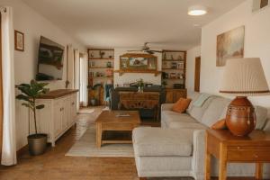 a living room with a couch and a table at El Ranchito Alegre Private 3BR Home in Historic Corrales in Corrales