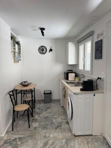 a kitchen with a washing machine and a table at Modern studio in Athens