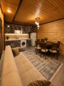 a living room with a large couch and a table at Beş Evler Apart in Uzungöl