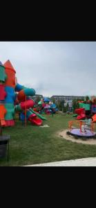 a park with a bunch of playground equipment at Novel in Korumdy