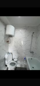 a bathroom with a toilet and a sink at Novel in Korumdy +5 photos