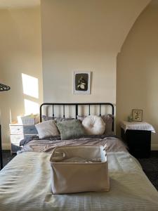 a bedroom with a large bed with a bag on it at The Blackburn 2 Bedroom House in Cherry Tree