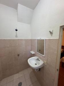 a bathroom with a sink and a mirror at Casa Santa Elena in Brisas de Zicatela