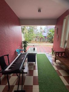 a room with a table and a green carpet at Mud apples stay in Varkala