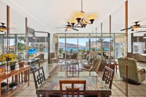 a living room with a table and chairs at Menehune Shores 606 - Direct Ocean Front, Split AC in Kihei