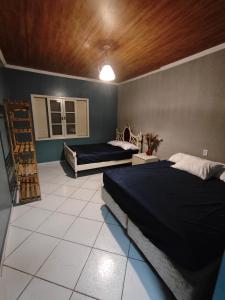 a bedroom with a large bed and a window at Sitio Chacara Piscina Aquecida Acesso Asfaltado in Juquitiba