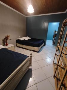a bedroom with two bunk beds and a ladder at Sitio Chacara Piscina Aquecida Acesso Asfaltado in Juquitiba +12 photos