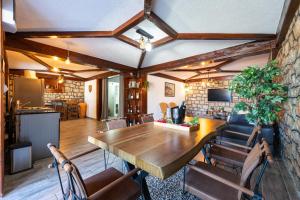 a dining room with a wooden table and chairs at Luna Pool Apartment in Danilovgrad +16 photos