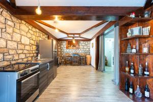 a kitchen with a stone wall and a counter top at Luna Pool Apartment in Danilovgrad